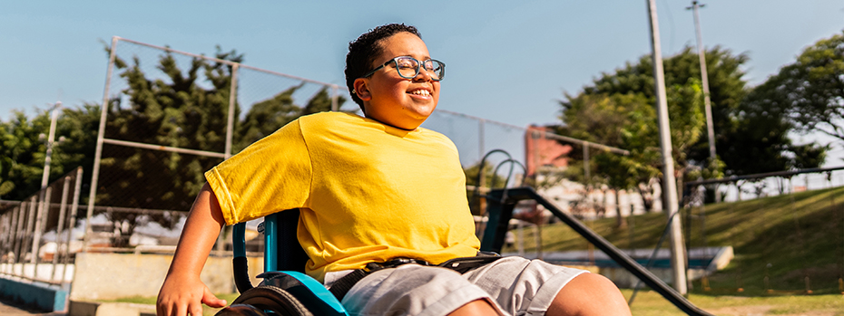 A child in a wheel chair smiling