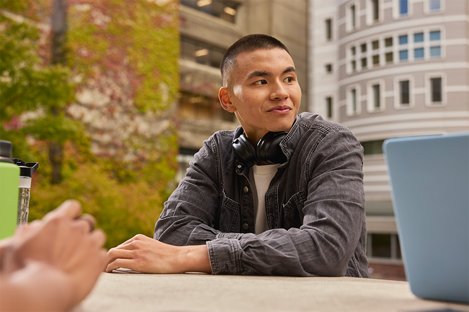 Student sitting at a table on OHSU’s Portland campus.