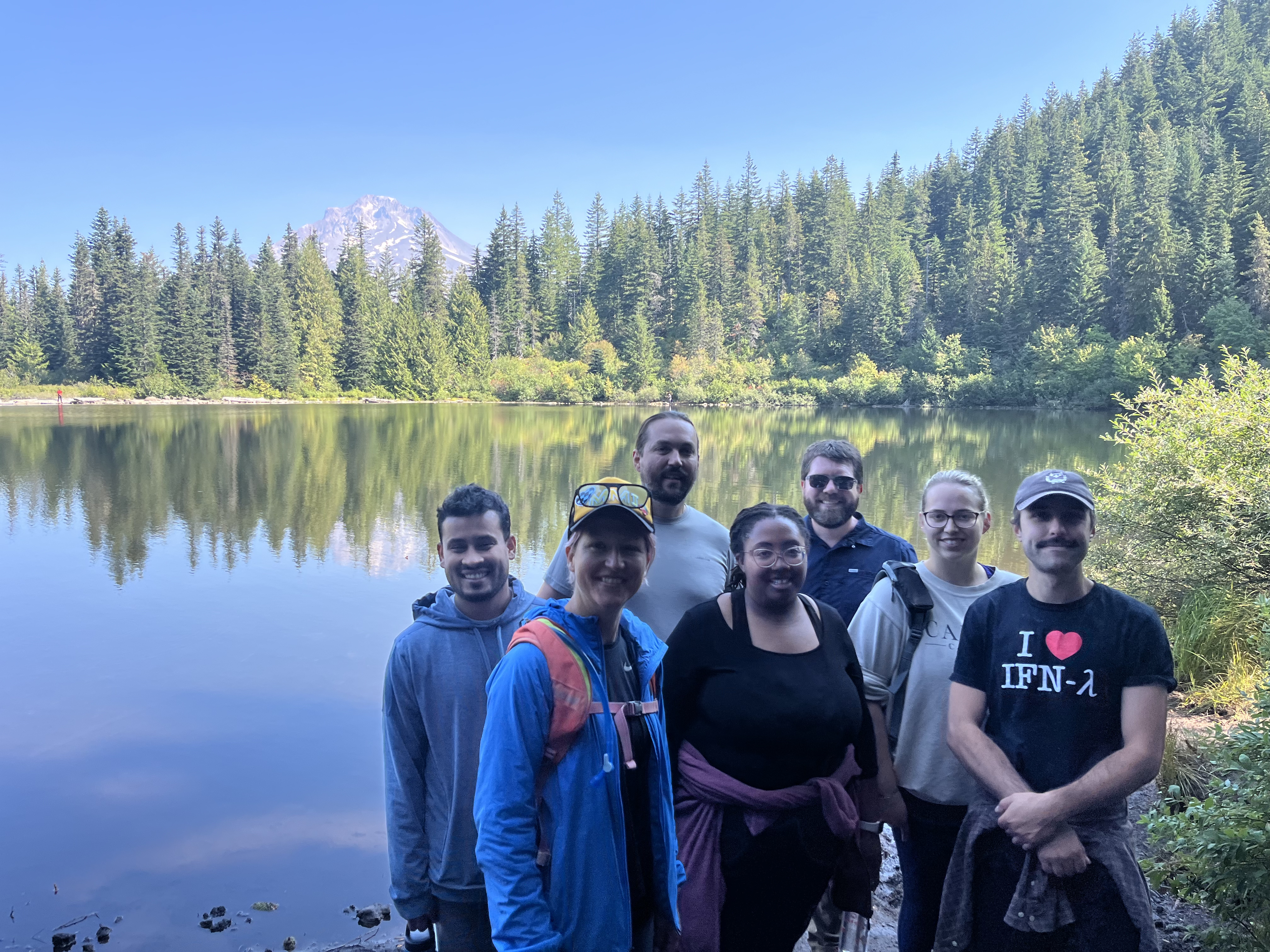 A group of people in front of a lake