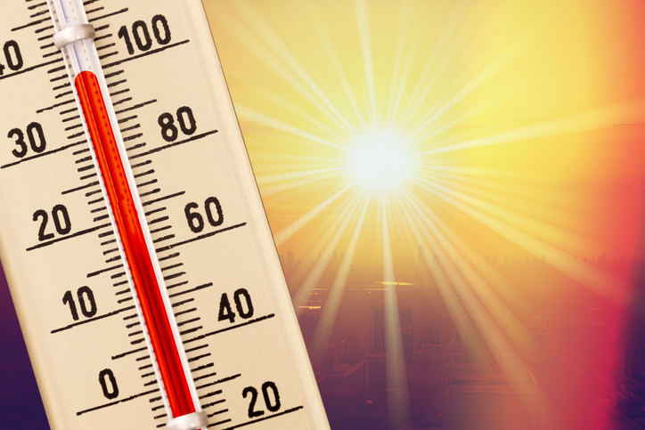 A thermometer in the sun indicating hot weather conditions.