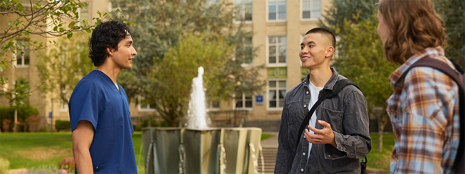 A group of OHSU students gather in front of Mac Hall.