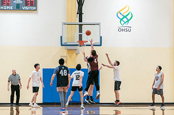 OHSU students playing an intramural basketball game. 
