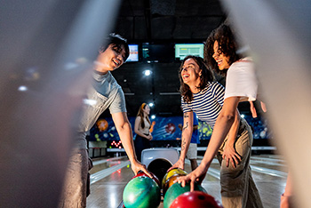 Bowlers enjoy a moment of friendly competition on the lanes.