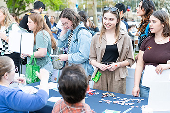 OHSU students socialize and learn at an information table.