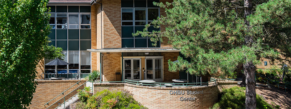 The sun shines on the exterior of the OHSU Student Center building.
