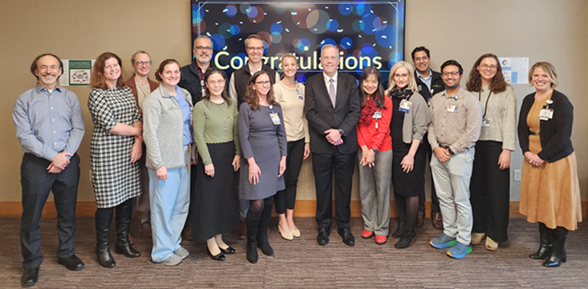 Group of leadership development program graduates posing with leadership.