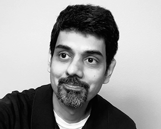 A black-and-white professional photo of Sudarshan Anand.