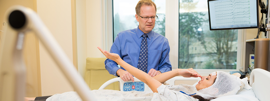 Dr. David Spencer works with a patient in OHSU’s epilepsy monitoring unit. 