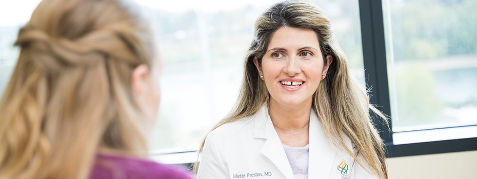 Portrait of Dr. Juliette Preston meeting with a patient.