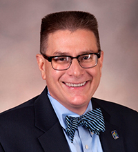 A professional headshot of neurology professor Dr. Kenneth Azarow.