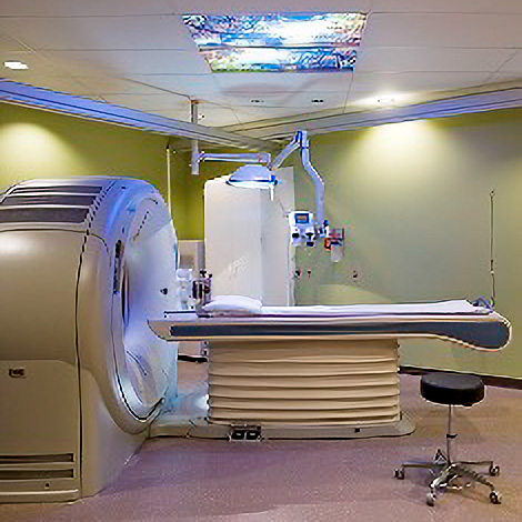 CT scanner with integrated radiation therapy equipment in an OHSU treatment room
