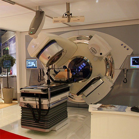 Image alt text: Linear accelerator with multi-leaf collimator system in an OHSU treatment facility.