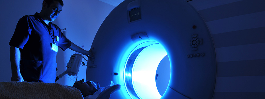 Health care professional positioning a patient for a scan.