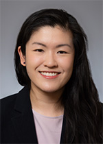 Dr. Michelle Tsai, in a suit jacket and blouse, smiles at the camera in a portrait.