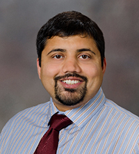 A professional headshot of Dr. Mubeen Jafri.
