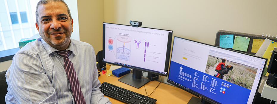 Portrait of Dr. Nizar Chahin next to a computer screen showing a diagram of neurons.  
