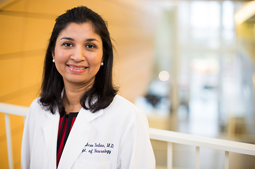 Photo of Dr. Vijayshree Yadav, M.D., in a white doctor coat smiling at the camera.