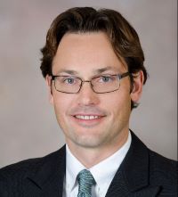 headshot of Dr. Alex Foster, smiling