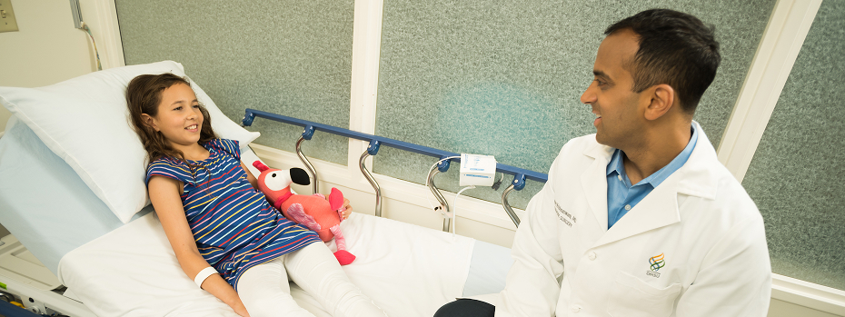 Dr. Sanjay Krishnaswami, a pediatric surgeon, talks with a pediatric patient at OHSU Doernbecher Children’s Hospital before surgery