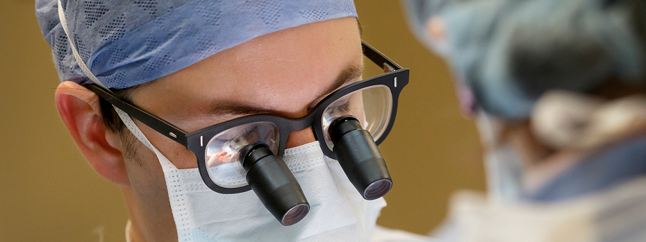 Close-up image of Dr. Jens Berli performing surgery wearing surgical loupes to magnify his view.