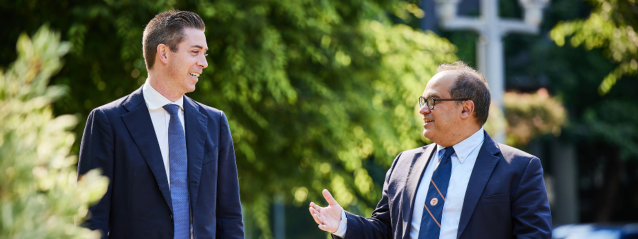Surgical oncologists Dr. Robert Eil (left) and Dr. Flavio Rocha (right) walk and talk on the OHSU campus.
