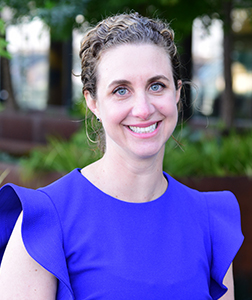 Dr. Erin Foster smiles for a portrait photo outside