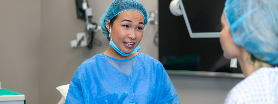 Young female surgeon talks with a patient before a medical procedure.