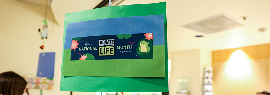 A sign hanging in a hospital reads "April is National Donate Life Month"