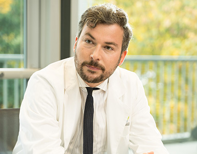 OHSU cardiologist Johannes Steiner, M.D., sits at a conference table listening to a colleague