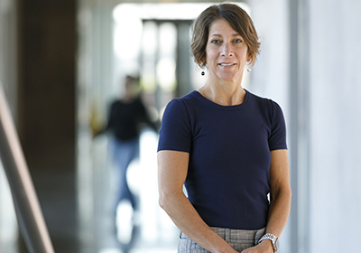 An OHSU scientist stands in a hallway.