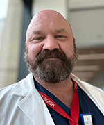 Photo shows Charles de Leeuw in an OHSU white coat.
