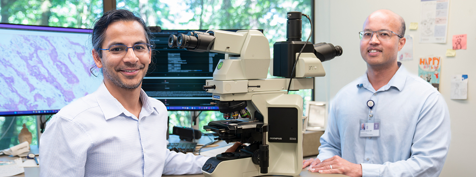 OHSU neuropathology team members, Dr. Nishant Tiwari (left), assistant professor of pathology and laboratory medicine and assistant residency program director, and Dr. James Davis, associate professor of pathology and laboratory medicine, pose for the camera in their lab.