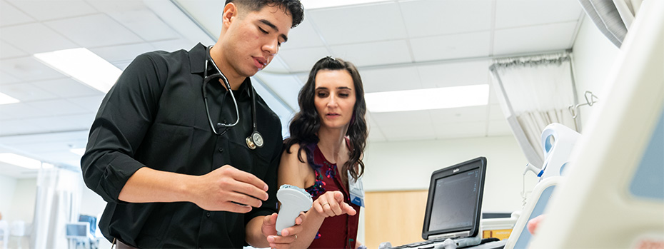 OHSU PA students train with a handheld ultrasound device.