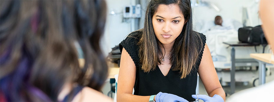 A PA students trains in a clinical skills lab