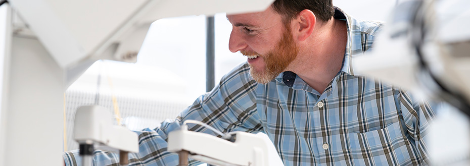 Dr. Alec Saitman, associate professor and director of clinical chemistry and toxicology at OHSU, evaluates an automated chemistry analyzer to ensure quality.