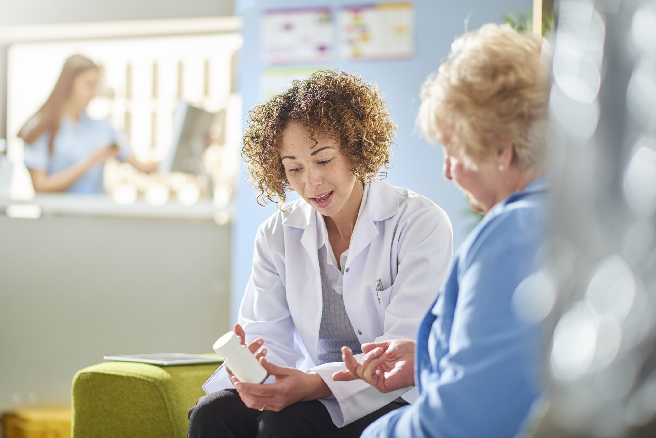 female-pharmacist-giving-older-woman-med-consult