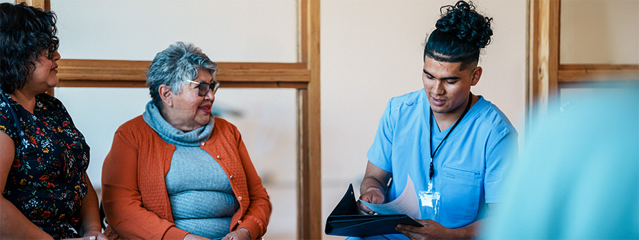 Health care professional meets with community members during a patient visit.