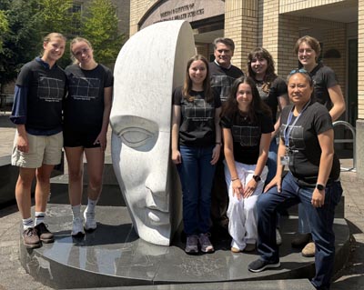 Morgan Lab 2026 standing next to the Vitae Mensae sculpture