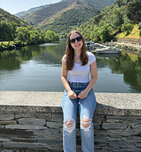 Anna Howard posing in front of a mountainous landscape