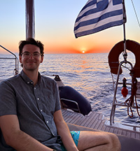 Brian Kirshey on a boat in front of a sunset