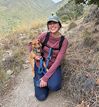Charlotte Kishi poses with her dog on a hike