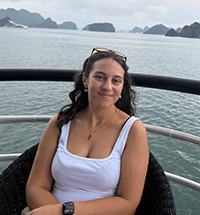Christina D'Ovidio on a boat surrounded by mountains