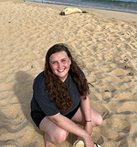 Christine Pons on a beach in front of a seal