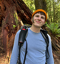 Jacob Fecht in the forest with a slug on the side of his face