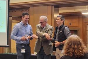 Dean Nathan Selden shaking hands with Drs. James Anstey and Michael Wollenberg