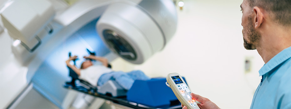 Radiation therapist monitors a patient during radiation treatment.