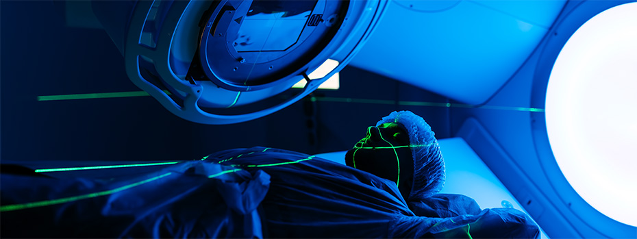 Patient positioned beneath a linear accelerator during a radiation therapy treatment session.