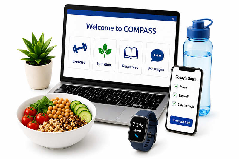 Laptop with a screen that says "Welcome to COMPASS" surrounded by a water bottle, fitness tracker and salad.