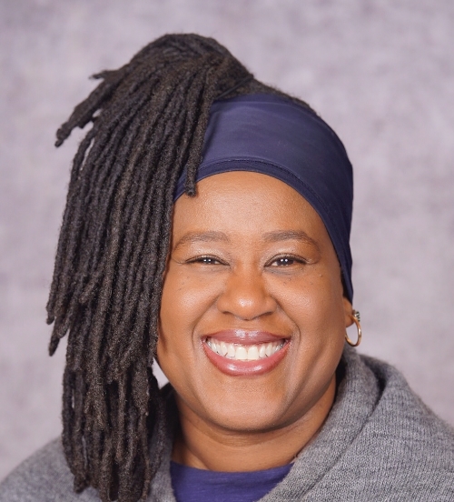 A professional headshot of Rosemarie Hemmings, a Black woman, smiling, against a neutral gray background.