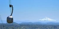Portland Aerial Tram rises past Mount Hood.